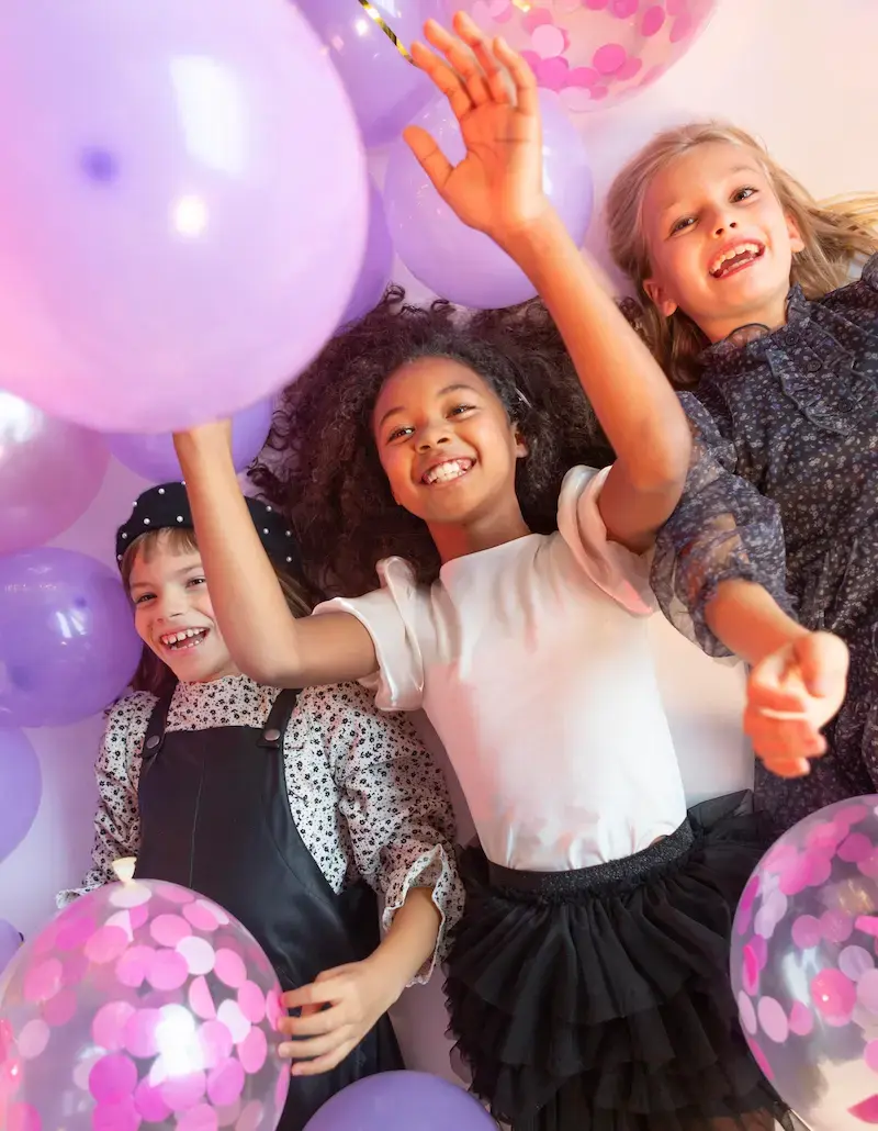 Kids celebrating with party balloons